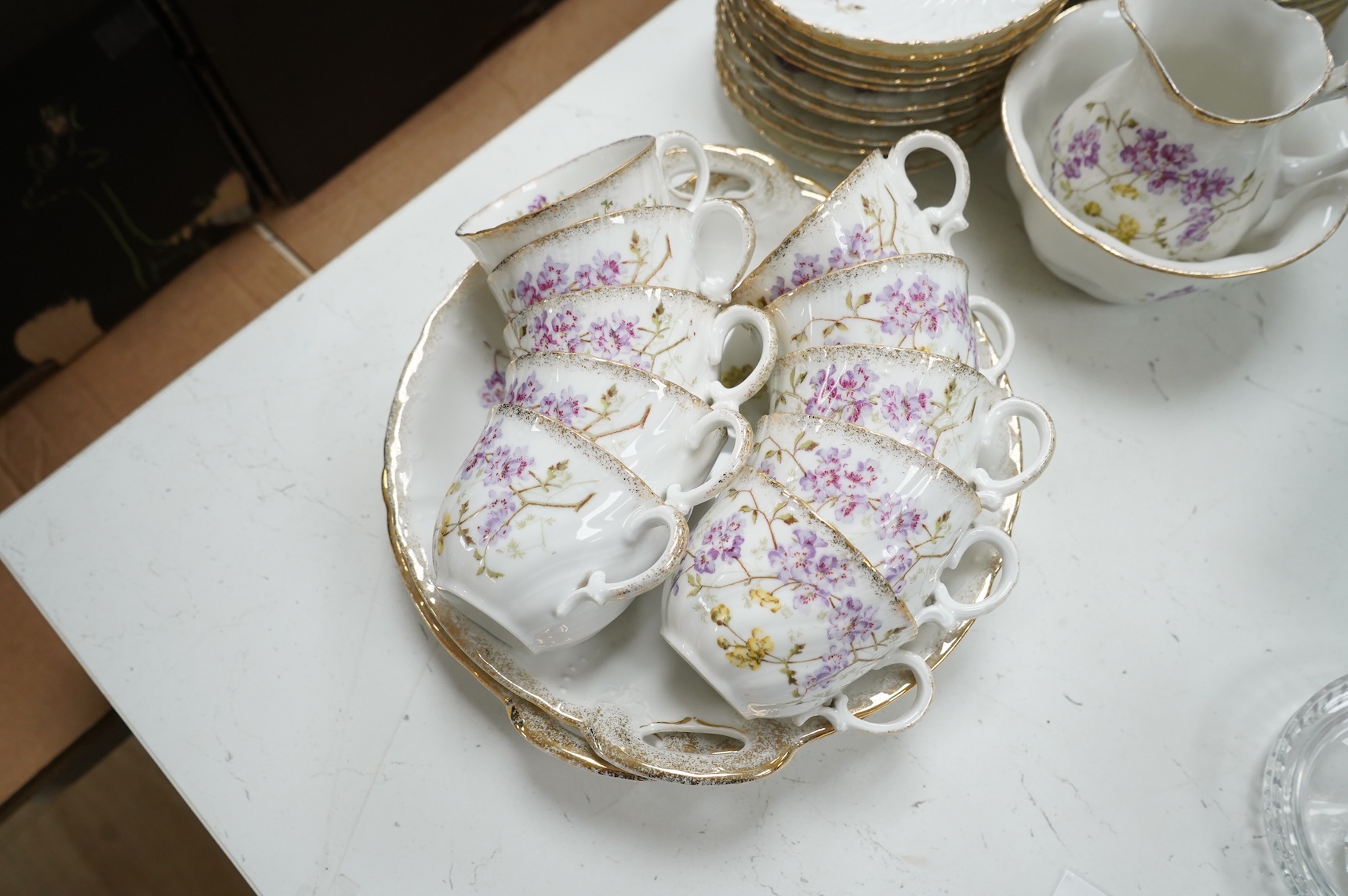 A KPM style floral porcelain part tea service, largest 27cm in diameter